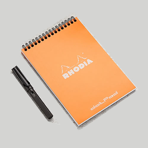 top bound spiral notepad with orange soft cover and black spiral, brande with a white logo